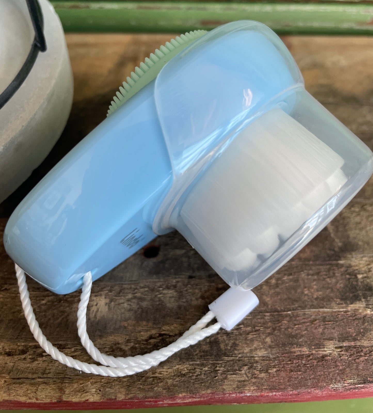blue and white mini travel face cleansing brush