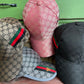 collection of honeycomb print hats in pink, brown, grey and black