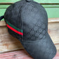 honeycomb print black hat with green, red and black stripe on side