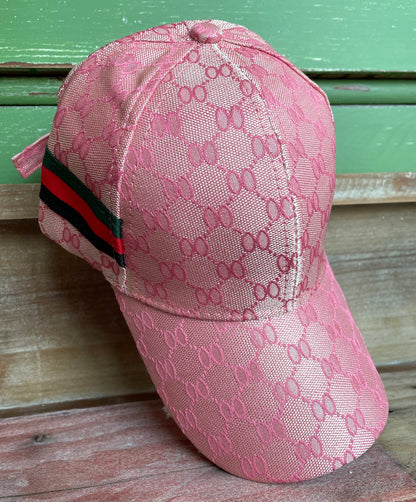 honeycomb print pink hat with green, red and black stripe on side
