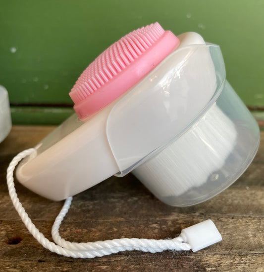 pink and white mini travel face cleansing brush 
